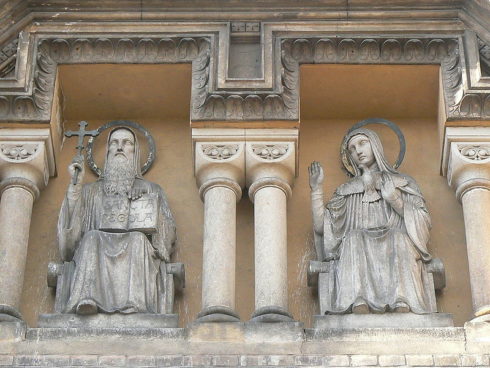 Statues of St. Benedict and his twin sister, St. Scholastica, above the entrance of the Church of the Annunciation, also called "St. Gabriel Church", in Holečkova Street in Prague-Smíchov, Czechia.