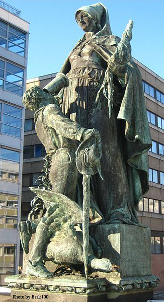 Statue of Saint Gertrude on Gertraudenbrücke in Berlin-Mitte by Rudolf Siemering (1896). St Gertrude's Bridge spans the Friedrichsgracht connecting the Spittelmarkt to Fisher Island. At its centre is this bronze statue of the Saint feeding a young boy a mug of beer or wine. Around the pedestal is a ring of rats and field mice.