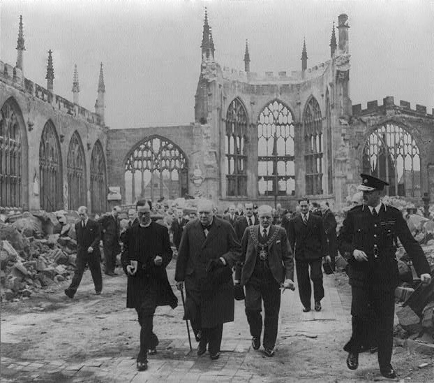 Winston Churchill walks through the ruins of Coventry Cathedral