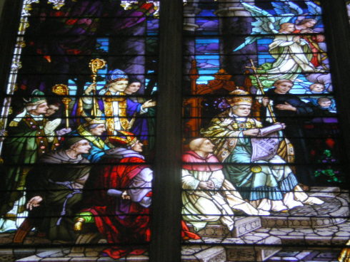 Close up of a stained glass window depicting the formal proclamation by Pius IX of the doctrine of the Immaculate Conception in 1854. 