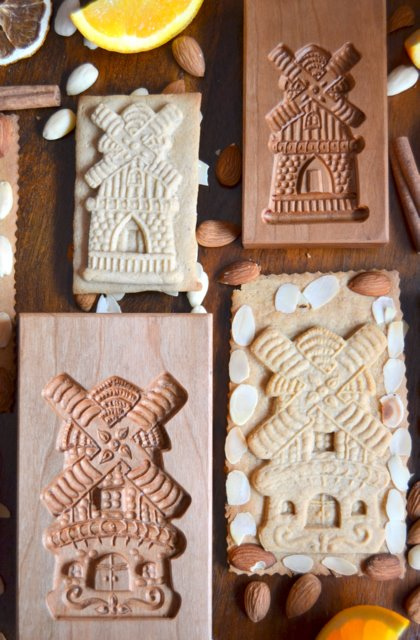 Speculaas, Spekulatius or Dutch Windmill cookies pictured with their molds. Traditionally speculaas are made by pressing the dough into a mold before baking in the oven. Traditionally speculaas are made by pressing the dough into a mold before baking in the oven. Traditionally speculaas are made by pressing the dough into a mold before baking in the oven. Traditionally speculaas are made by pressing the dough into a mold before baking in the oven. 