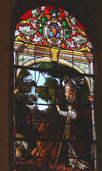 Stained glass window of Pope St. Cornelius protecting the cattle from the diseases at Saint Cornely Church, in Brittany.