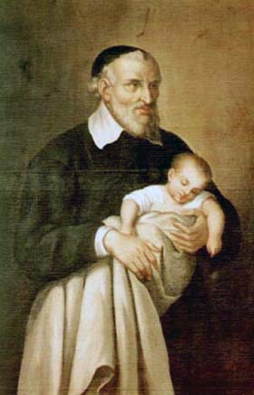 Vincent de Paul holds sleeping infant, wrapped in blanket