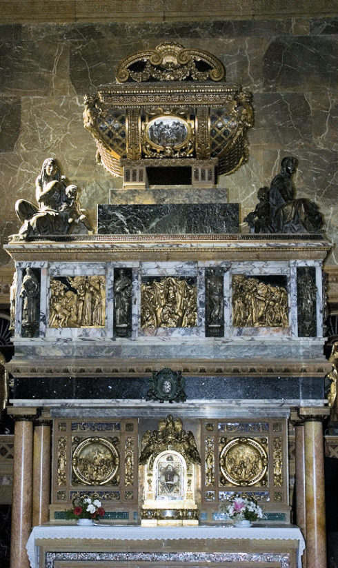 The tomb of St. John of the Cross, suspended high above the side chapel's altar by four pillars. There are two altars on either side of the tomb so two priests can say Mass simultaneously. 