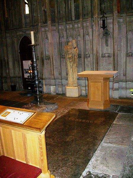 St Cuthbert's Tomb, in Durham Cathedral. Also showing a (headless) statue of St Cuthbert - holding the head of the king St Oswald - whose head is reputed to have been buried with St Cuthbert.