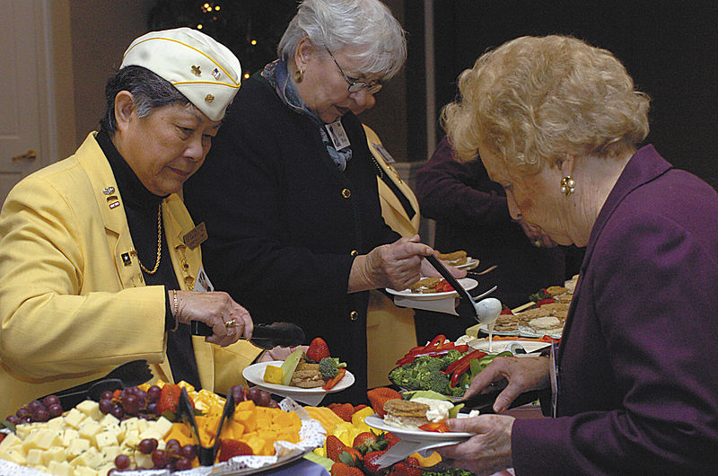 Members of the Gold Star Wives, enjoying a buffet of fruit, finger sandwiches, cheese and vegetables Friday at the Military Widows and Widowers High Tea event.