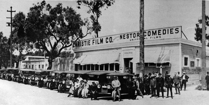 1913-Nestor Studios. The first motion picture studio in Hollywood was built by David Horseley for Christie Film Co. Automobiles are lined up at Sunset Blvd.